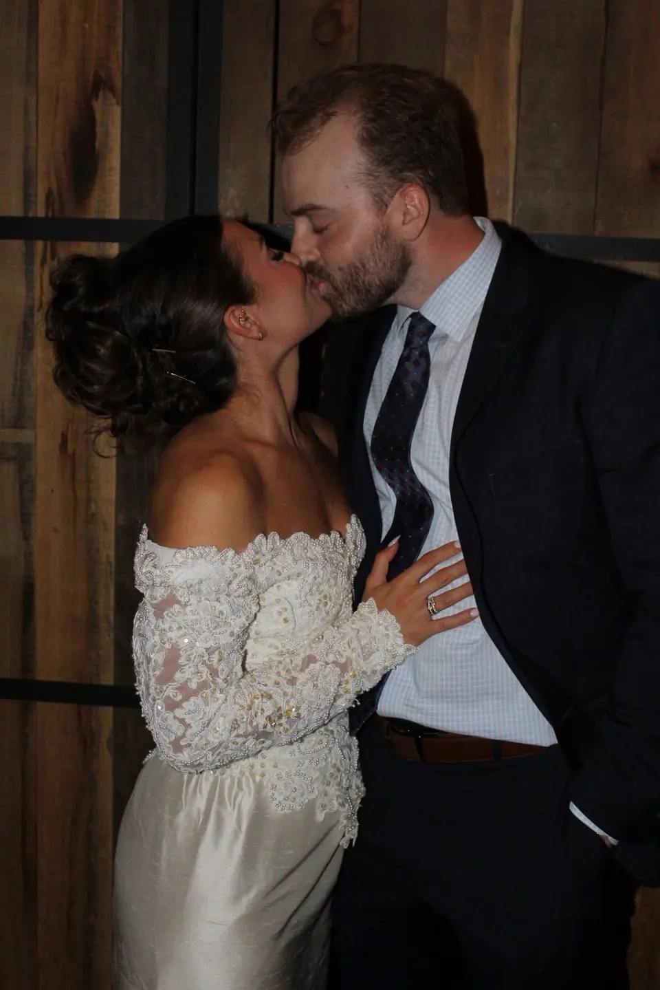 A newly married couple sharing a kiss