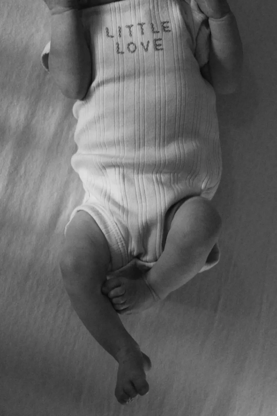 A black-and-white newborn portrait